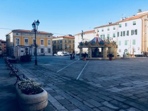 giostra in piazza Matteotti a Sarzana con pavimentazione lastricata e palazzo comunale sullo sfondo. location scout duzimage